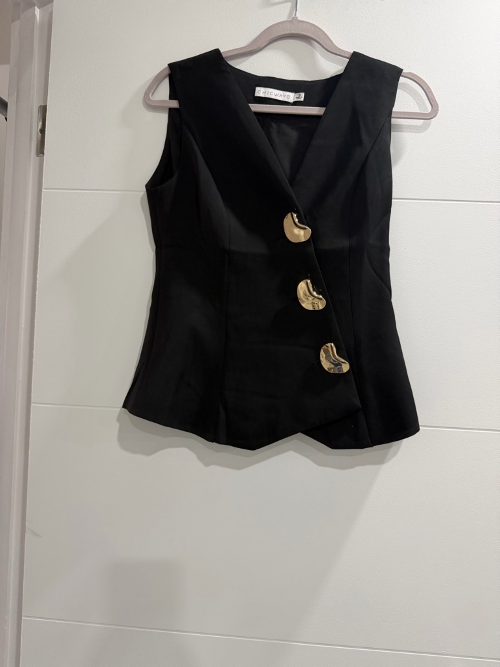 Chic v-neck black sleeveless vest with gold buttons